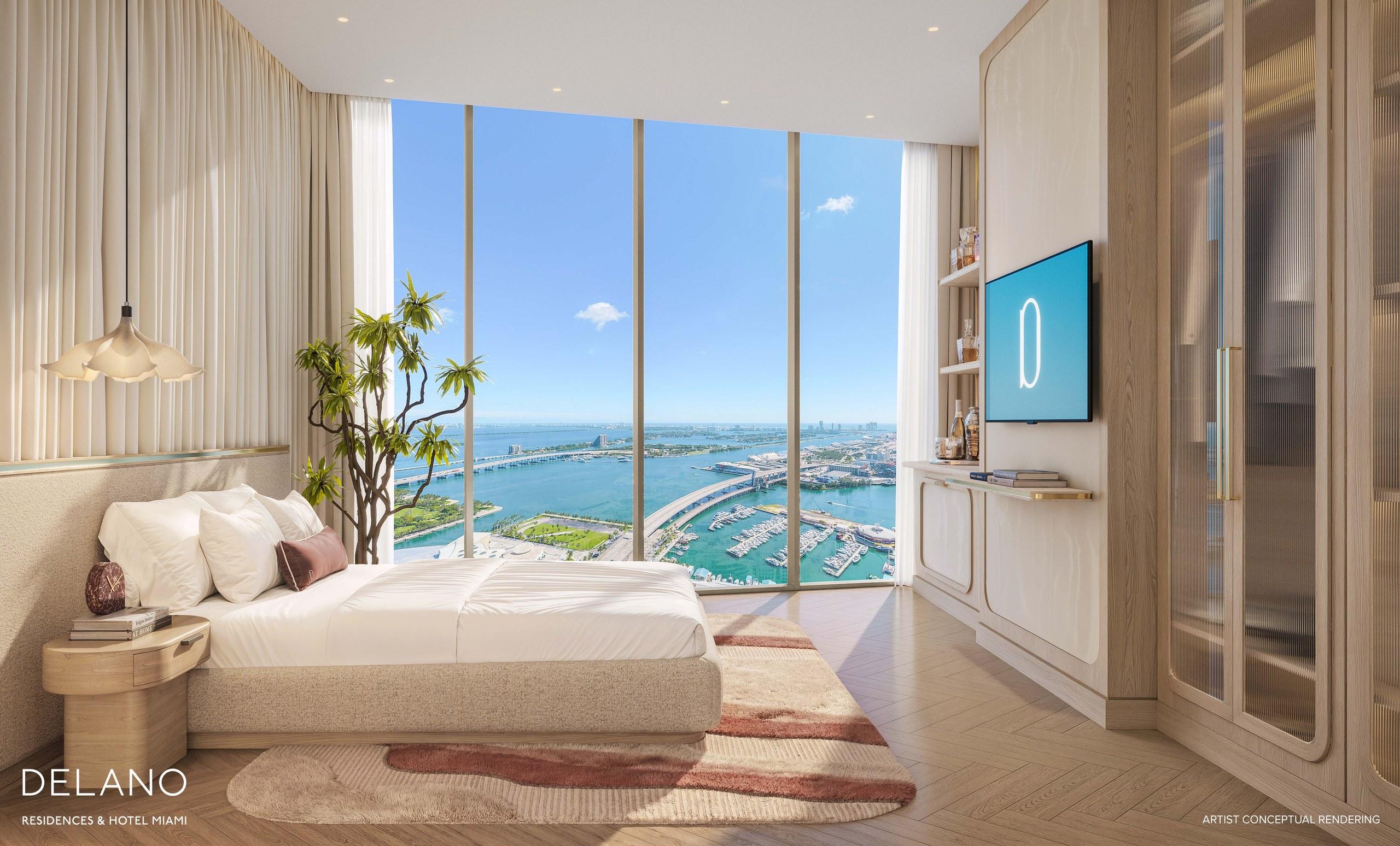 A residence bedroom at Delano Residences with floor-to-ceiling glass framing Biscayne Bay
