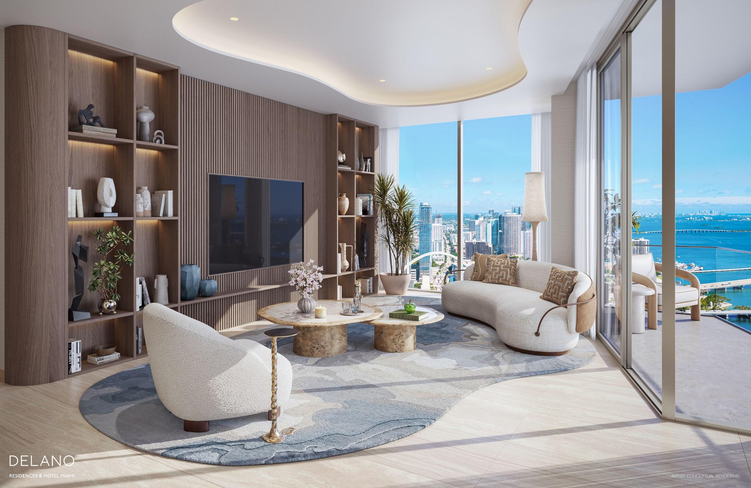 A great room at Delano Residences with curved seating and bay views through floor-to-ceiling glass