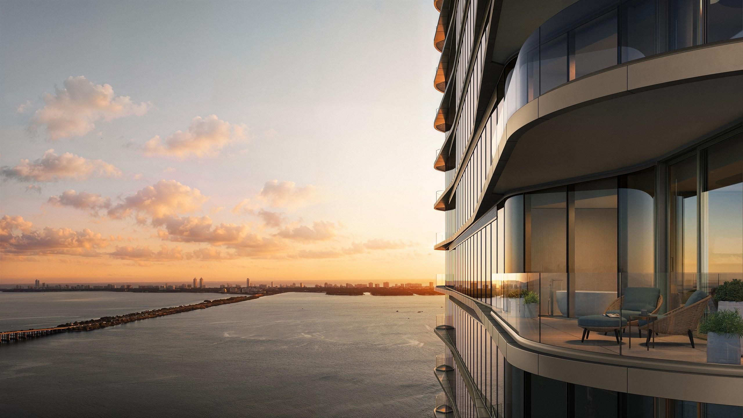 Curved residence terraces at LiLLi Edgewater above Biscayne Bay at golden hour