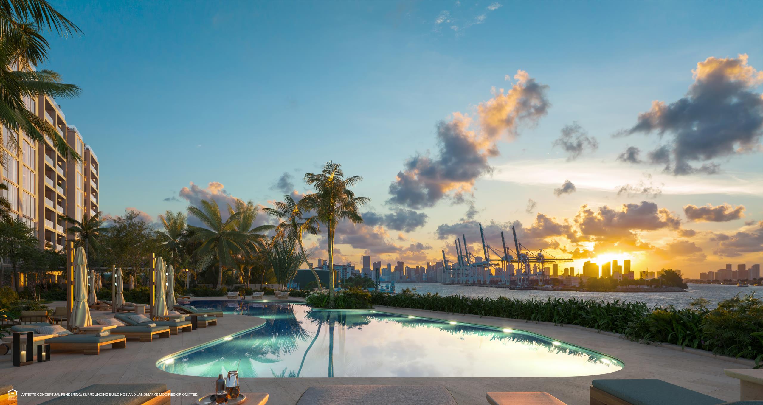 Bayfront pool deck with cabanas and gardens facing Biscayne Bay at Six Fisher Island