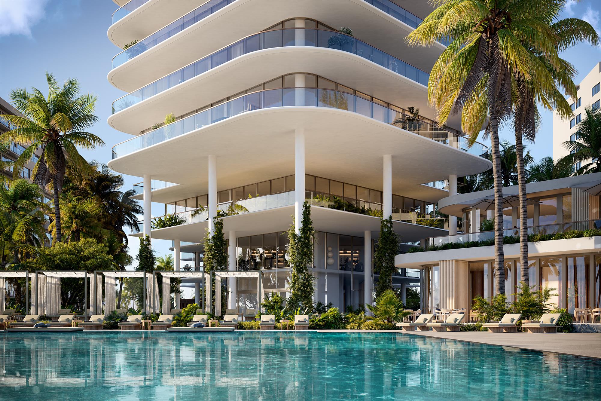 The beachfront pool, private cabanas, and oceanfront restaurant terrace framed by palms