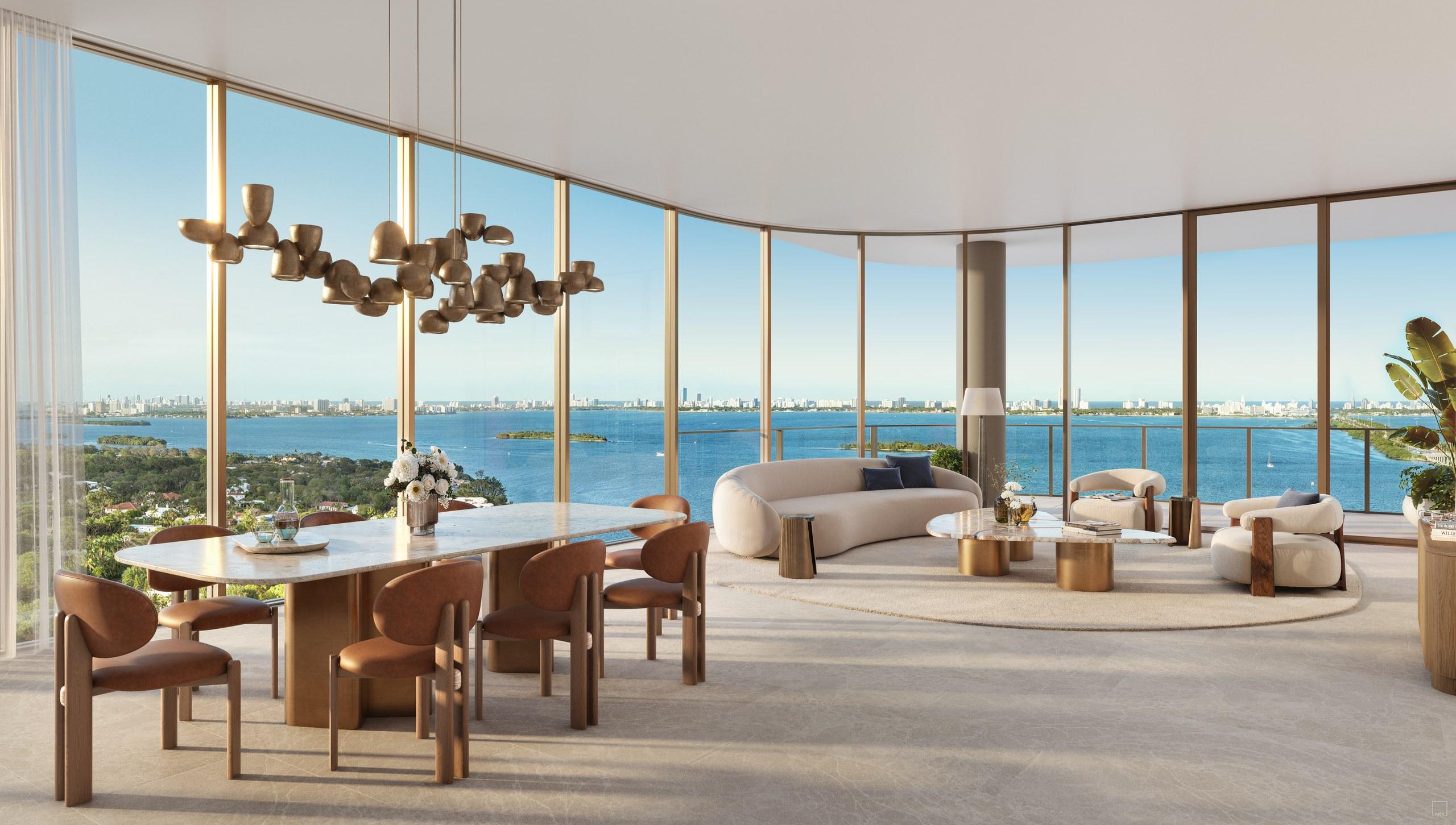 Dining and living space behind curved floor-to-ceiling glass at Kempinski Residences