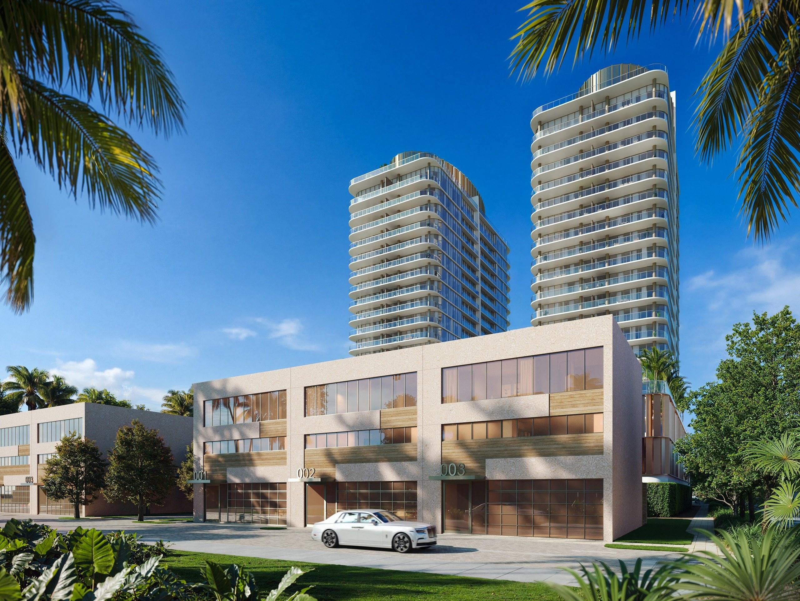 The twin Kempinski towers seen from the street, rising behind the low-rise residences at their base